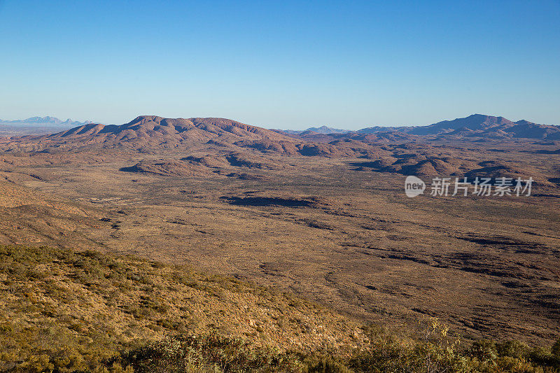 在一个晴朗的日子里，从松德山(Mount Sonder)的峰顶望去，西麦克多纳山脉(West macdonald ranges)灯火辉煌